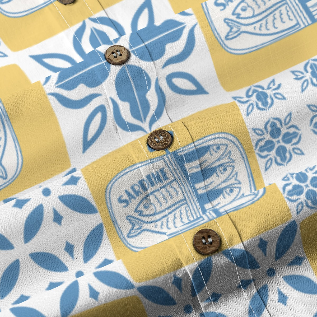 Close-up of the Sardine Shirt buttons with blue tiles and sardine tin illustrations
